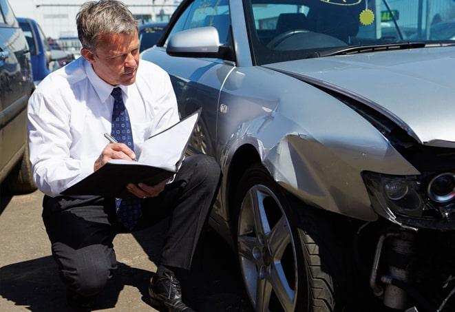 auto insurance policy in a leather folder